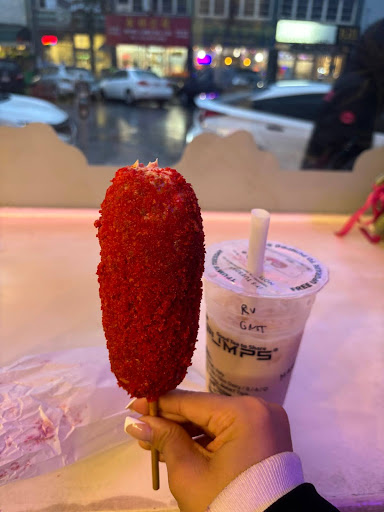 Korean corndog covered in Hot Cheetos and filled with cheese (left) and rose vanilla green milk tea boba (right)