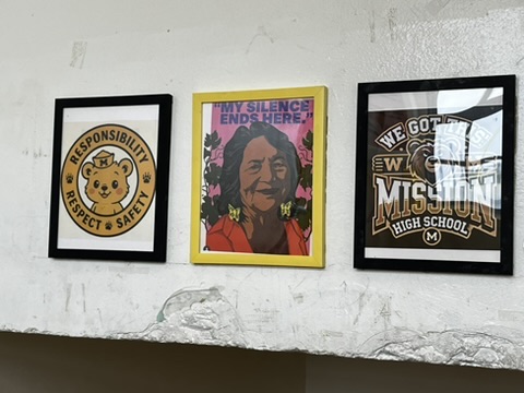 Portrait of Dolores Huerta, alongside art of Mission High School. 